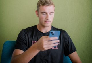 Jacob Kautman checks Campus Town Trading messages on his phone