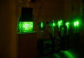 Photoelastic beads lit by a green laser.